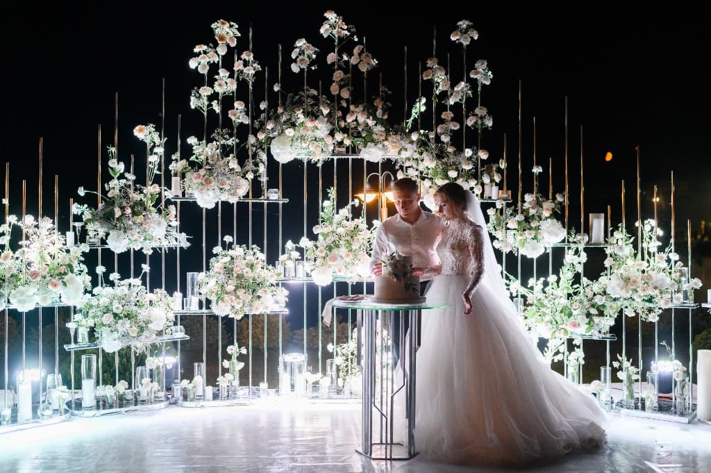 Bride and groom cutting their wedding cake at an evening reception